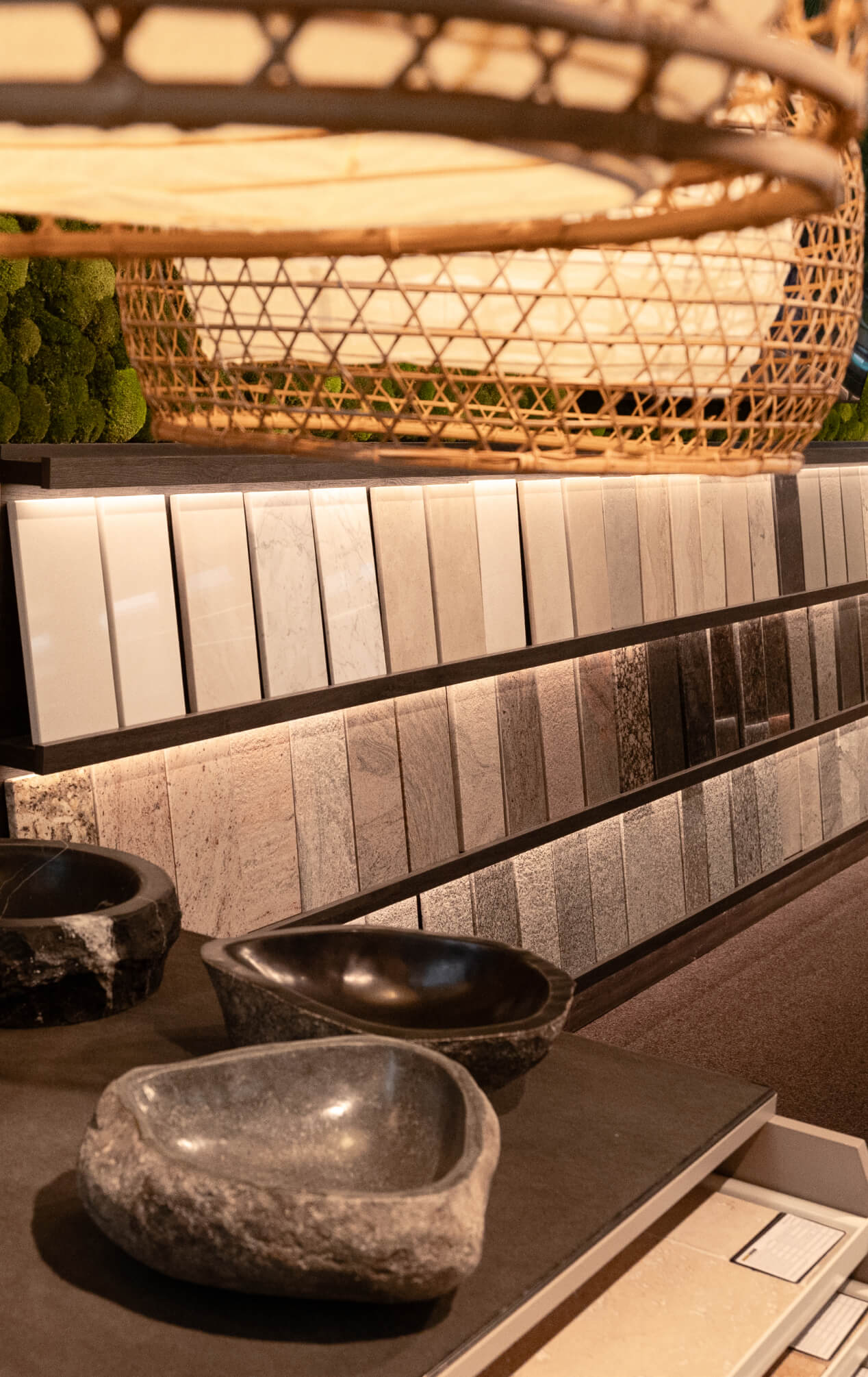 Präsentationswand mit Stein- und Keramikmustern in warmem Licht