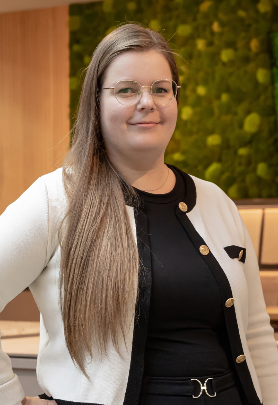 Junge Frau mit langen Haaren in heller Jacke in einem Showroom
